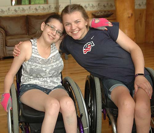 Taylor Dumke, 22, of Wesley Chapel, Florida, left, and Brynn Duncan, 16, of Moorhead, Minn., have been roommates at the National Wheelchair Sports Camp at Ironwood Springs Christian Ranch for seven years. This year's camp was held June 9-15.