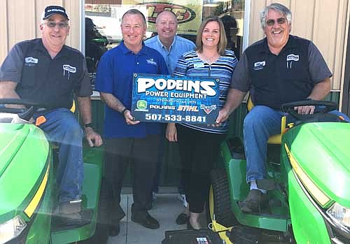 Mike Podein, far left, and Mark Podein, far right, owners of Podein's Power Equipment, accept congratulations on their business's current expansion from, clockwise from second from left, Mayor Jimmie-John King, Bill Schimmel Jr., city administrator; and Gwen Stevens, director of member and community relations for People's Energy Cooperative, which provided Podein's Power Equipment with $100,000 in gap financing to help pay for the expansion.