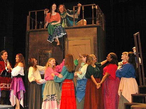 The Gypsy Singer (Iz Kramlinger) and Quasimodo (Dave Stepan) enjoy watching the Gypsy dancers from a balcony during a dress rehearsal for the Stewartville Community Theatre's upcoming performance of The Hunchback of Notre Dame, set to debut at the Stewartville High School Performing Arts Center this Friday, Aug. 4 at 7:30 p.m.