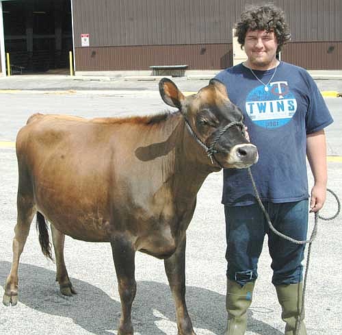 George Skare stands with "Comet," a Jersey fall yearling, at the Olmsted County Fair.