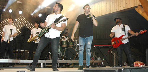 Danny Gokey, a top-three finalist on season eight of American Idol, in the center wearing the black shirt, was the featured performer at the annual Miracles Happen Festival at Ironwood Springs Christian Ranch on Saturday evening, July 29. A large audience watched Gokey and his band perform.
