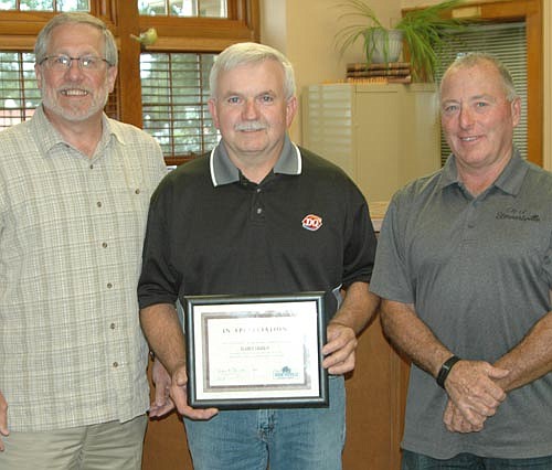 Jeff Bagniewski, owner of Stewartville's Dairy Queen, center, accepts the Economic Development Authority's Business Appreciation Award from Chris Stafford, EDA president, left; and Mayor Jimmie-John King, a member of the EDA.