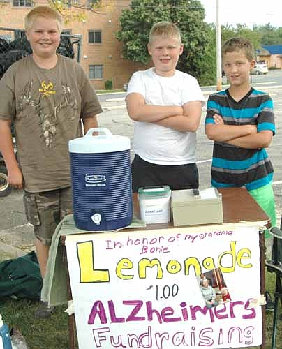 LEMONADE FOR A GOOD CAUSE -- From left, Michael Anderson, Ethan Monty and Keaton Gehling sold lemonade from a stand near the Stewartville STAR office last week. The boys, who opened the stand on four separate occasions, raised a total of about $300 for Alzheimer's disease research. They planned to attend an Alzheimer's Walk in Walker, Minn. the weekend of Aug. 26-27, then give the money to the Alzheimer's Association.