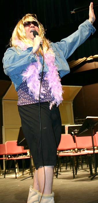 TEENYBOPPER -- Hannah Montana, otherwise known as Joe Jezierski, principal of Stewartville Middle School, performed for a large group of middle school students at the SHS Performing Arts Center on Thursday, March 20. By reading for a total of 138,000 minutes, middle school students won a bet with Jezierski, who paid the price by lip-synching a Hannah Montana song.  Jezierski's performance drew a loud ovation and calls for an encore.  