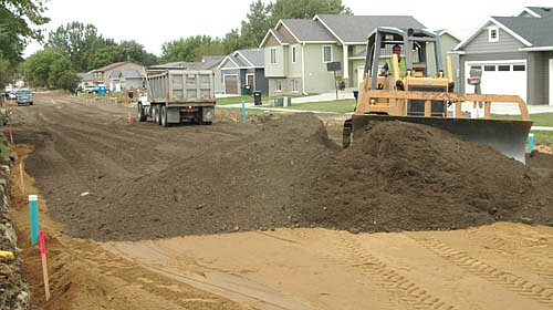 A crew from Alcon Construction continued to work on portions of Sixth Street Northeast last week. The Rochester firm is expected to repair Sixth Street Northeast and Fairway Court for $1,065,130.00, considerably less than the city engineer's construction estimate of $1,202,740.00. Above, Bobby Carr of Stewartville moves earth along the street.