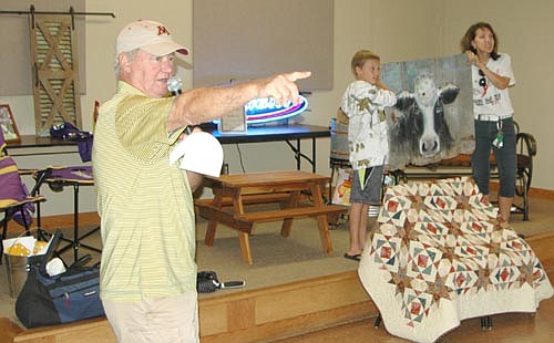 WALKIN' AND TALKIN' -- Participants at the fifth annual Seize the Day, Cure Blood Cancers took place at the Stewartville American Legion Post 164 on Sunday, Sept. 10. Here, Steve "Ike" Wangen, left, auctions off a painting of a cow during a live auction at the Legion. Angie McGill and friends organize the event in memory of Angie's mother, Glenda Kollasch of Bancroft, Iowa, who died of leukemia in September 2012. Proceeds will go to the to Mayo Clinic's hematology research and the Med City Foundation, McGill said. Seize the Day, Cure Blood Cancers raised about $5,000 this year.