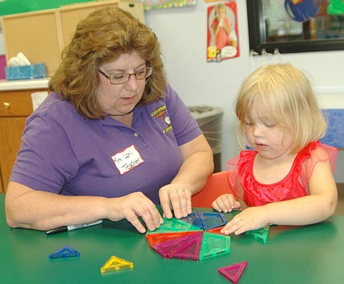 Lori Torgerson, a Wee Care teacher, assists Izabelle Slovinski with puzzle pieces at the annual Wee Care open house on Sunday, Sept. 10. Sixty-two children are enrolled at Wee Care for the 2017-18 school year.