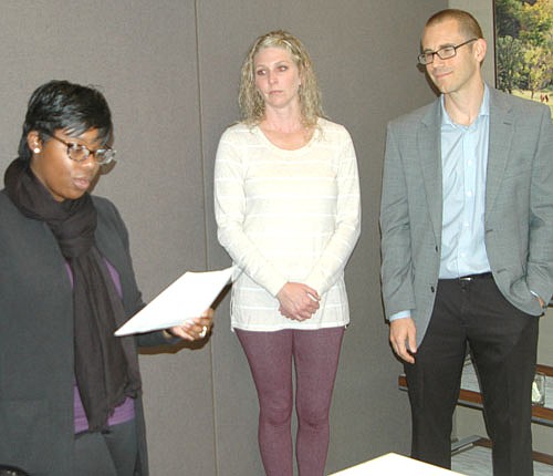 Shawntera Hardy, commissioner of the Minnesota Department of Employment and Economic Development (DEED), left, prepares to present a certificate of appreciation to GEOTEK of Stewartville, represented by Mollie Forstner, human resources director, center, and  Ben Wiltsie, president and CEO.