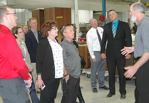 Mike Smith, manufacturing engineer at Halcon, far right, leads a tour of Halcon's working space to begin the celebration of Minnesota Manufacturing Week last Tuesday, Oct. 3. Officials who took the tour include, starting from fourth from left, state Rep. Nels Pierson, state Sen. Carla Nelson, Jimmie-John King, mayor of Stewartville, and Bill Schimmel Jr., city administrator. Community and Economic Development Associates (CEDA) partnered with the state of Minnesota's Department of Employment and Economic Development (DEED) and Journey To Growth (J2G) to host tours of manufacturing facilities in four southeastern Minnesota communities, including Stewartville, Rochester, Blooming Prairie and Caledonia.