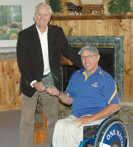 Bruce Remme, executive director of the Ability Building Center (ABC) of Rochester, left, presents Bob Bardwell, director of Ironwood Springs Christian Ranch, with the award naming Ironwood Springs an outstanding employer of people with disabilities.