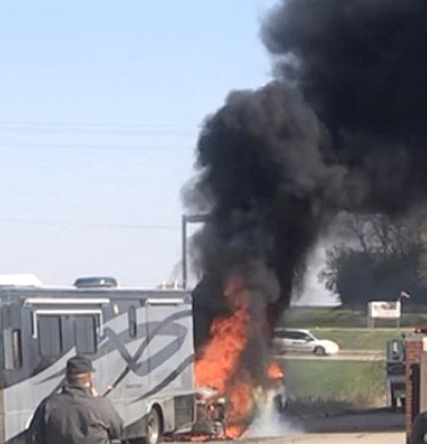 Black smoke rises from a flaming 2017 Chevrolet Silverado pickup truck attached to a motor home near the north Kwik Trip in Stewartville on Wednesday, Oct. 25. 