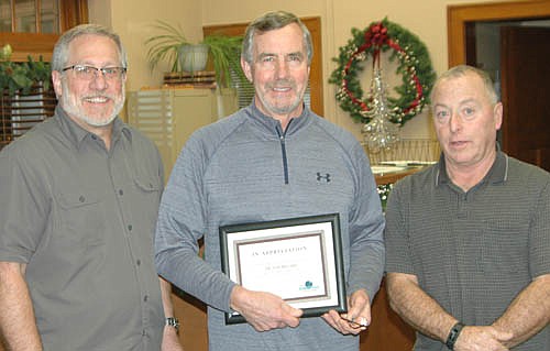 Dr. Tom Bro, center, who has served as a dentist in Stewartville for almost 43 years, accepts the Economic Development Authority's Business Appreciation Award from Chris Stafford, EDA president, left; and Mayor Jimmie-John King, an EDA member.