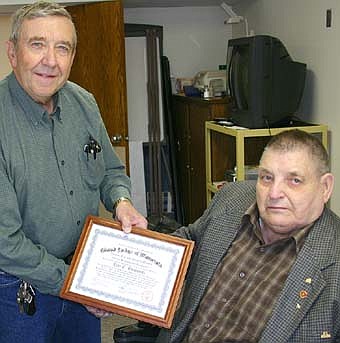 A HIGH HONOR -- Lyle Buchholtz, seated, accepts a certificate honoring him for his 60 years in good standing as a member of the Pleasant Grove Masonic Lodge. Phil Soderberg, past Masonic Grand Master of Minnesota, left, presented the certificate. 