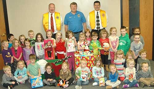 In back, from left, Bill Schimmel Jr., Dr. David Thompson and Troy Knutson of the Stewartville Lions Club visited St. John's Wee Care at St. John's Lutheran Church on Thursday,&#8200;Nov. 30 to collect gifts donated by Wee Care families to the annual Lions Club Christmas Anonymous gift and fund drive. Each year, the Lions deliver the items to a distribution center in Rochester, where the presents are made available to Olmsted County children who might not otherwise receive a Christmas gift.