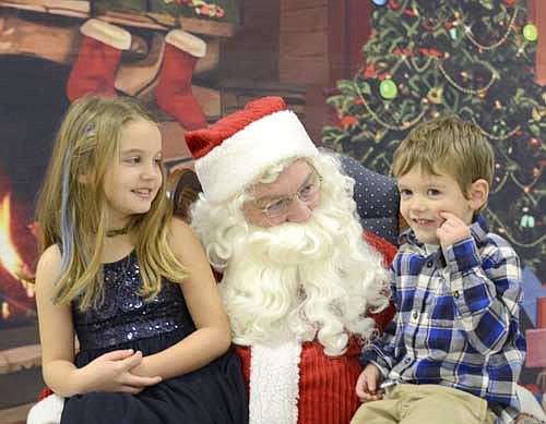 Gracey Gunderson, 8, left, smiles at her brother Gage, 4, as the siblings sit on Santa's lap during the Stewartville Kiwanis Club's annual Pictures with Santa event at the Stewartville Civic Center on Saturday morning, Dec. 2. About 80 groups of children, many with more than two in each group, told Santa all about what they wanted for Christmas from 9 a.m. until about 12:15 p.m. that day. Many more photos of children visiting Santa will be featured in the Stewartville STAR's annual Holiday Section, scheduled for distribution on Tuesday, Dec. 19.