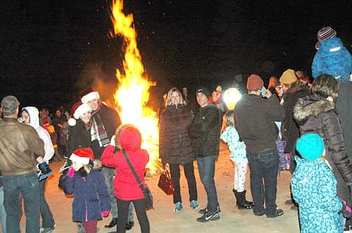 Local and area residents warmed themselves near a bonfire at the Stewartville Area Chamber of Commerce's annual Winterfest celebration at Florence Park on Saturday evening, Dec. 2.