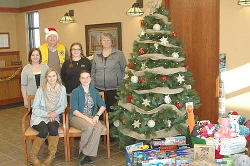 Bill Schimmel Jr. of the Stewartville Lions Club, standing in back, visited First Farmers&Merchants Bank last week to collect items donated by the bank's customers and friends to the Lions Club's annual Christmas Anonymous gift and fund drive. First Farmers&Merchants Bank employees include, front row, from left, Stephanie Lawson and Anna Serrano. Back row, from left, Kayla Munsch, Schimmel, Tiffany Titus and Pam Wilson.