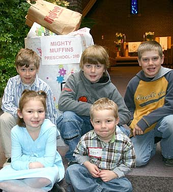 LEARNING TO HELP OTHERS -- The Mighty Muffins, a preschool- through third -grade group at Stewartville United Methodist Church, won a recent contest by donating 181 pounds of food to the Channel One Food Shelf. Members of the group include, front row, from left, Emma Thomason and Jayce Cast. Back row, from left, Logan Kidd, Joe Finley and Cody Keefer. The Cheese Puffs, a group of fourth- through sixth-graders, placed second in the contest by donating 174 pounds of food, and the Hot Potatoes, a group of seventh - through 12th graders, gave 142 pounds. The church gave the food in conjunction with the Minnesota Food Share March campaign. 