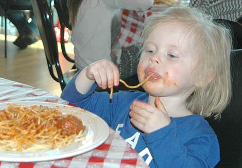 Gracelynn Drees, 2, of Stewartville, enjoyed her spaghetti one noodle at a time at the St. Bernard's Catholic Church Men's Club's biennial Mama Tranchita Spaghetti Dinner at Riverview Greens Country Club on Tuesday, March 28.