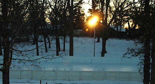 The sun sets below the trees on a cold late afternoon near the ice rink at Stewartville's Florence Park on Wednesday, Jan. 3. Temperatures dipped below zero every day or night from Christmas Day through early January in southeastern Minnesota.