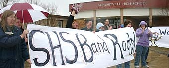 WELCOME HOME -- Parents stood in the rain to welcome the Stewartville High School Band back to Stewartville last Monday, March 31.  The band earned first-place awards in concert and parade competitions at a festival in Wiliamsburg, Virginia. 