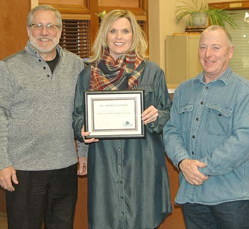 Jen Martin, owner of Ejuvenate Therapeutic & Sports Massage, center, accepts the Economic Development Authority's Business Appreciation Award from Chris Stafford, EDA president, left, and Mayor Jimmie-John King, a member of the EDA.