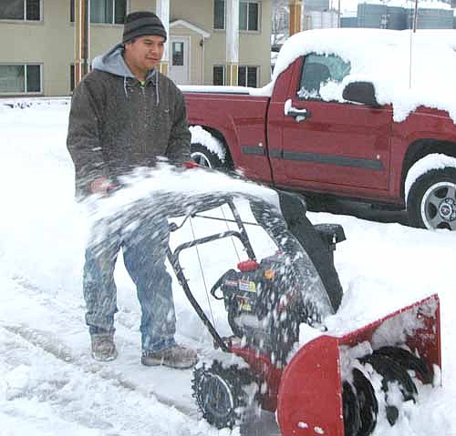 Roberto Narciso, who lives on Second Ave. Southwest, Stewartville, used a snowblower to clear his sidewalk after a winter storm dumped plenty of snow on Stewartville and the area last week.