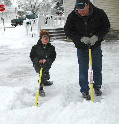 Caden Nagel, a second grader at Bonner Elementary School, shovels snow with his dad, Craig, on Tuesday morning, Jan. 23. A Jan. 22 winter storm dumped about 8.5 inches of snow on Stewartville.