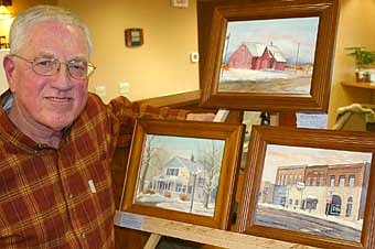 Tom Johnson of Rochester is one of eight area artists whose work was featured at a reception for "The Rural Scene Art Show" at First Farmers&Merchants State Bank last Thursday, April 3. Johnson put a number of his works on display, including three watercolors depicting Stewartville and area landmarks. Clockwise from lower left. Johnson's works include "North Main, Stewartville," a drawing of Tom Bro's dentist office; "Southwest of Stewartville," a picture of a barn; and "Stewartville STAR," which depicts a section of downtown Stewartville. A large gathering of  local and area residents enjoyed the show, which highlighted works by Johnson, Sharon Brodhun, Jenni Cachiaras, Donna Cortese, Gayle Dahl, Jim Elton, Charles Pearson and Tammy Schneider.  The artists' works will be on display at the bank through this Friday, April 11. 