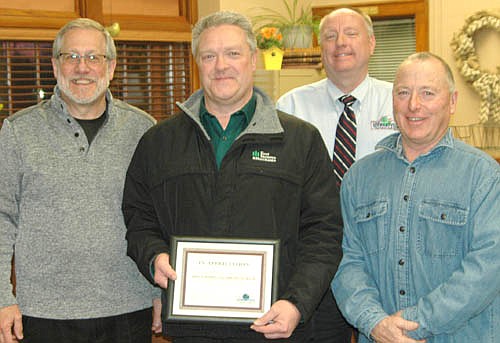Dave Feddersen, president and CEO of First Farmers&Merchants Bank, front and center, accepts the EDA's Business Appreciation Award from, left to right, Chris Stafford of the EDA, Bill Schimmel Jr., city administrator; and Mayor Jimmie-John King, an EDA member.