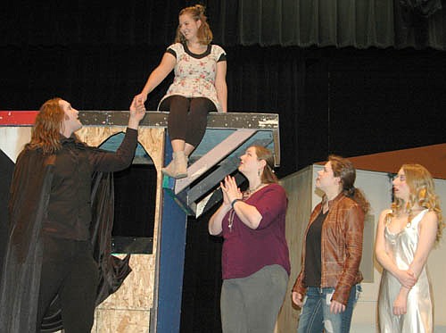 Dracula (Dave Stepan) left, meets Mina (Katie Eberhard) seated above, during a dress rehearsal for Stewartville Community Theatre's upcoming presentation of Dracula, the Rock Musical! Standing at right, from left, Elizabeth (Melissa Kloempken), Jane (Emma Hansen) and Lucy (Darien Hilmerson) worry that Mina is under Dracula's spell. Stewartville Community Theatre will present the show at the Stewartville High School Performing Arts Center this Friday, March 2 and Saturday, March 3 at 7:30 p.m. each evening, and this Sunday, March 4 at 2 p.m.