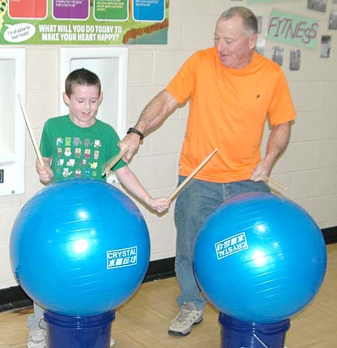 Mayor Jimmie-John King, right, and his grandson Emmit King, a second grader at Bonner Elementary School, enjoy a drum cardio workout during the annual Jump Rope for Heart event at the Bonner gym on Thursday, Feb. 22.