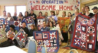 A WARM WELCOME HOME -- Stewartville and area veterans, including Greg and Tiffany Ziemer of Stewartville were touched when a group of women from Mabel presented them with 20 peacemaker quilts at the "Operation Welcome Home" celebration at Ironwood Springs Christian Ranch Friday through Sunday, March 28-30.  Tiffany Ziemer was especially grateful to Bob Bardwell, director of Ironwood Springs, for coordinating the event. 