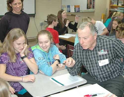 Mayor Jimmie-John King, a member of the city's Economic Development Authority, right, visited the eighth graders in Dawn Miller's health class at Stewartville Middle School last week to discuss the students' views on the city of Stewartville. From left, eighth graders Allie Elliot and Kylie Smidt listen to the mayor's questions as Miller looks on in the background.