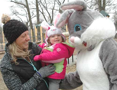 Ashlynn Anderson, 2, of Stewartville, held by her mother Kristin, is one of many children who met the Easter Bunny during the Sons of the American Legion's Easter Egg Hunt at Florence Park on a cold and windy Saturday morning, March 31.