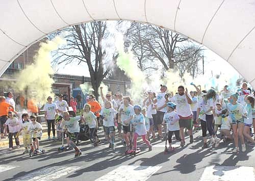 Some of the 245 participants get blasted with color at the start of the third annual Stewartville Color Run Walk Stroll 5K, which began near the Central Education Center on Saturday morning, May 5.