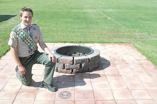Ethan Humble, a junior at Stewartville High School, kneels at the site of his Eagle Scout project, a fire pit and pavers near Zion Lutheran Church. "The actual project was a lot of grunge work," he said. "There was 25 hours digging up the dirt. It was a lot of planning, definitely." Ethan officially became an Eagle Scout at a Court of Honor ceremony in the fellowship hall at Zion Lutheran Church on Sunday, May 6.