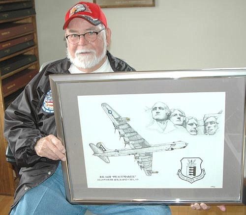 Ross McInroy of Stewartville enlisted in the United States Air Force in 1952, serving as a radio operator, electronic countermeasures operator, forward right gunner and forward cabin boy. He holds a drawing completed by his son, Zane McInroy, principal of Bonner Elementary School, depicting the RB-36 bomber on which the elder McInroy flew during the 1950s, along with Mount Rushmore, so drawn because Ross McInroy was based at Ellsworth Air Force Base, Rapid City, S.D.