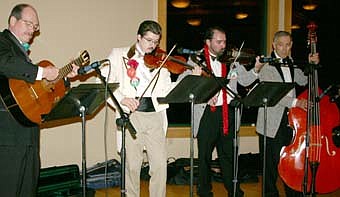STRING MUSIC -- A quartet of instrumentalists provided entertainment at the St. Bernard's Men's Club Mama Tranchita dinner at Riverview Greens Country Club on Tuesday, April 15. The group included, from left, Ronn Carlson on guitar, Alex Weston and Peter Hogan on violin and John Diffley on string bass. 
