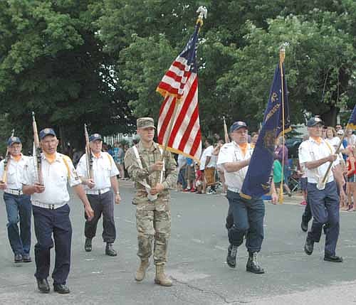 THANKS TO THE MILITARY -- Spectators on both sides of the street removed their hats and applauded as representatives of the military marched past during the Summerfest Parade.