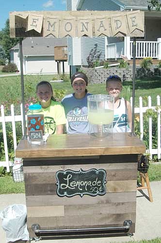 EMONADE FOR SALE -- From left, Josie Kahoun, Avery Spencer and Johanna Kahoun sold lemonade for 50 cents a glass from a homemade Stewartville stand last week. "We've been out about six days," Josie said. "One day we made about $28. It's pretty fun. You get to enjoy the outdoors." John Kahoun, the Kahoun girls' dad, made the stand.