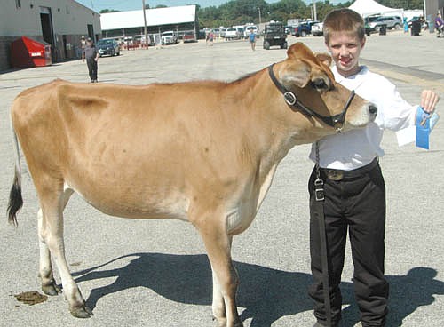 Kenny Skare, 11, who will be a sixth grader at Bear Cave Intermediate School, earned a blue ribbon and a special merit award with his jersey spring yearling at the Olmsted County Fair.