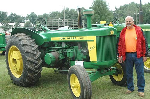 Bob Johnson of Racine stands near his 1958 John Deere 820, the largest of the five John Deere models he brought to the 36th annual Root River Antique Historical Power Association Antique Engine and Power Show south of Racine on July 20, 21 and 22.