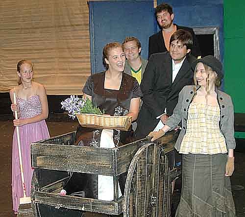 Eliza (Katie Eberhard), in cart, pretends to be "royalty" while her friends play along during a scene for the Stewartville Community Theatre production of My Fair Lady, to continue with three more performances at the Stewartville High School Performing Arts Center this Friday, Aug. 10 and Saturday, Aug. 11 at 7:30 p.m. each evening, and on Sunday, Aug. 12 at 2 p.m. From left are the Flower Girl (Taylor Godbout), Harry (John-Michael Eberhard), George (Brandon Lange), Jamie (Ryan Frank), and Rose (Darien Hilmerson). For ticket reservations, go to www.stewartvilletickets.com.