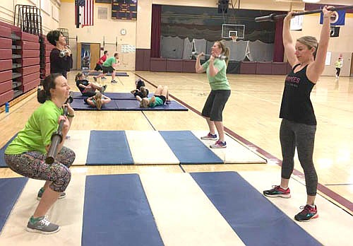 Clockwise from front left, Jennifer Marshall-Adolphs, Pam Stoltenberg, Briana Bicknese and Ashley Jones lift weights during a recent Stewie Kraze exercise session.
