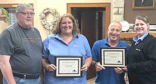 Heather Reed, second from left, and Treena Perzynski, far right, Kwik Trip managers, accept the EDA Business Appreciation Award from Jim Kuisle, EDA president, far left, and Mayor Jimmie-John King, a member of the EDA, second from right.