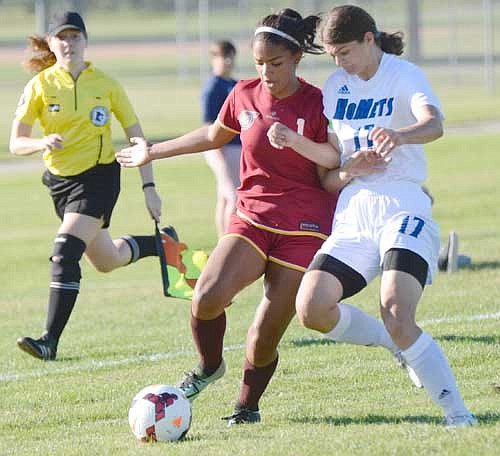 Attacker Hailey Lewis beats a KoMet defender to the ball and cuts inside for a charge on goal.