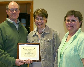 AWARD WINNERS -- Ronn and Shirley Carlson of Stewartville, left, received the Stewartville Area Historical Society Preservation and Restoration Award for their work on their Sixth Street Southwest home. Vicki Meredith, Historical Society president, presented the award at the organization's annual meeting last week. 