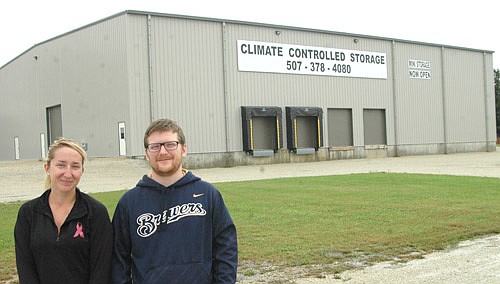 Allie Fryer, rental manager and office assistant, left, and Cole Mullenbach, estimater at Racine Storage, stand near the company's new 16,000 square-foot building that will offer a total of 104 climate-controlled storage units in a variety of sizes.