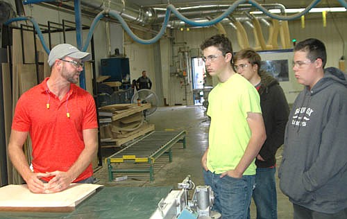 J.D. Siemback, veneering manager at Halcon, left, speaks to Stewartville High School students, from left, senior Shawn Boyle, junior Tanner Lee and junior Mitchell Jay, who were part of a group of 34 SHS students who toured Halcon and McNeilus Steel of Dodge Center on Tuesday, Oct. 2. Halcon and GEOTEK of Stewartville were among 24 southeast Minnesota manufacturers that opened their doors to almost 350 high school and college students from 17 communities during Minnesota Manufacturing Week, Oct. 1-7.